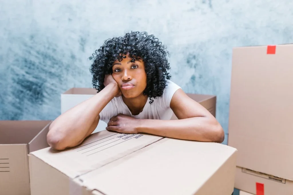 woman surrounded by moving boxes