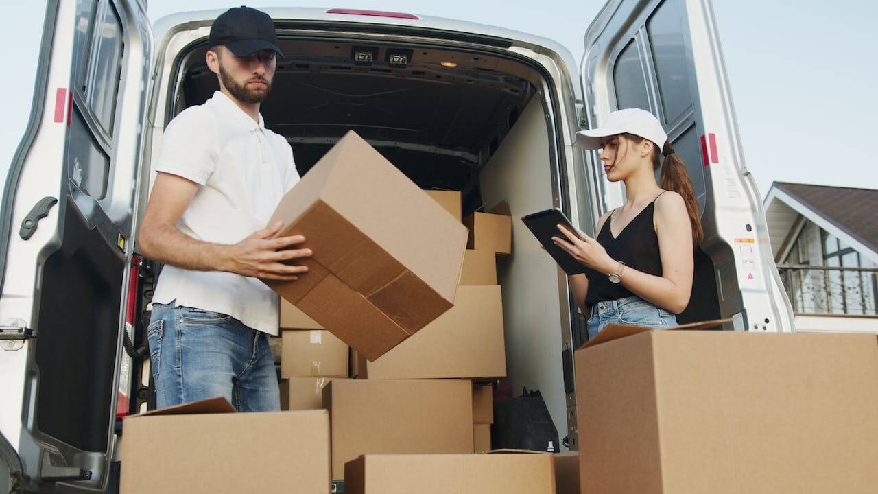 man and woman unloading a van